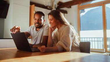 Couple happily creating their financial plan for the new year.