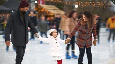 Couple thinking about Northwestern Mutual’s Weekly Market Commentary as they help their daughter keep her balance.