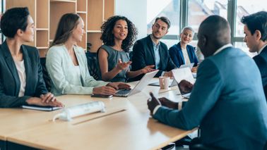 Boardroom meeting of employees forming a financial plan for the coming quarter