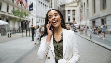A smiling, confident Wall Street businesswoman actively investing in her future and working toward financial security with expert guidance from a Northwestern Mutual Wealth Management Company certified financial planner. This image conveys financial success, modern wealth management, and professional financial planning.
