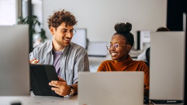 Male and female colleague in a modern office. This image conveys financial success, modern wealth management, and professional financial planning.