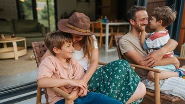Family sitting on porch outside