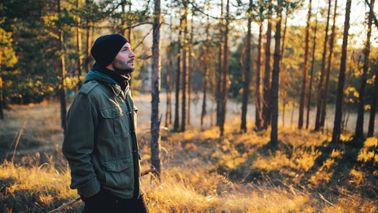 Young man walking in the forest