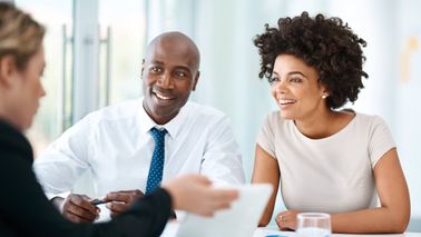Co-workers outlining a financial plan in a modern office.