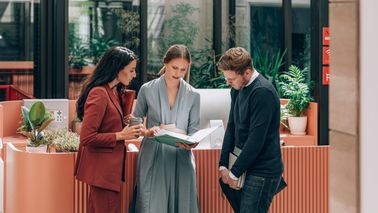 Group of businesspeople discuss financial strategy and investments in modern office