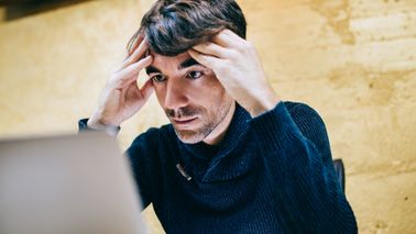 man frustrated with internet fraud