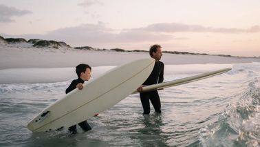 Father and son enjoy surfing trip while celebrating financial freedom and a solid plan with Northwestern Mutual