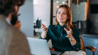 Shot of two colleagues having a discussion in the office.