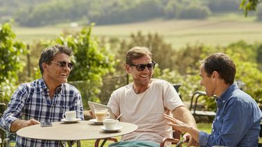 Friends talking about what they read in Northwestern Mutual’s Weekly Market Commentary.