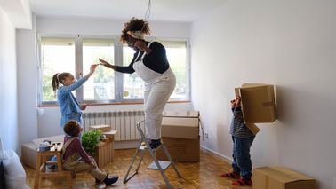A mother with her two kids moving into a new home