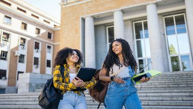 two women walking and chatting 
