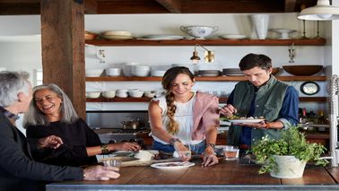 family cooking together in kitchen