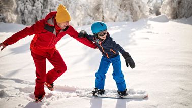 Father and daughter enjoying a winter escape powered by a solid financial plan with Northwestern Mutual.