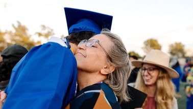 Grandmother hugs graduate 