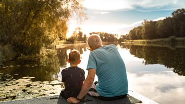 grandfather and grandson on the water