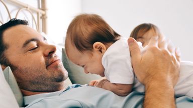 Dad playing with son thinks about his retirement savings before college savings