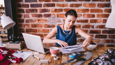 Woman at her desk researching how to start a small business