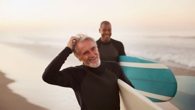 Older men surfing after managing debt in retirement