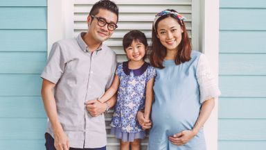Young family posing for a picture.