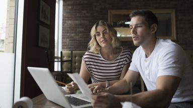A young couple reviews their finances together