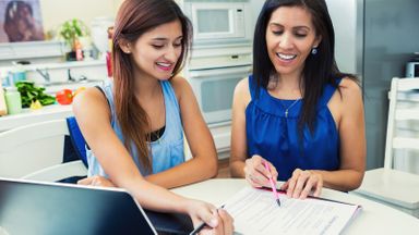 Mother and daughter filling out a college application.