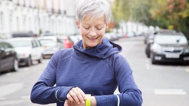 woman looking at fitness watch