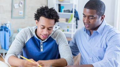 dad-and-son-discuss-paying-for-college-with-IRA