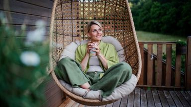  Woman feeling financially confident and enjoying her newly purchased home.