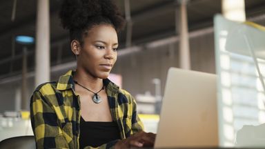 Woman at a desk looking at her computer while researching long-term disability insurance 