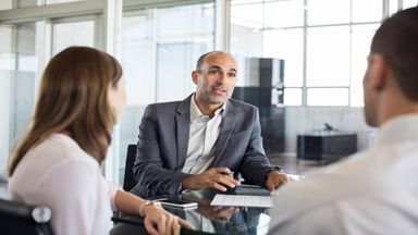 A couple talks with an investment advisor