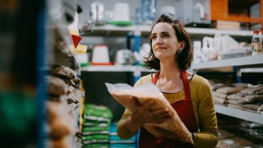 A woman stands at her job after starting a new career at 40.