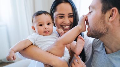 A young couple enjoys time with their baby.