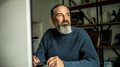 Man sitting at a desk thinking about getting a job to supplement retirement income