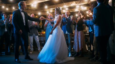 A couple dances in a wedding tent 
