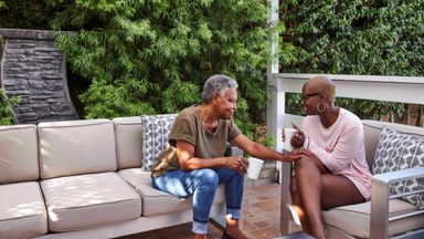 Adult female discussing a serious topic with mother on patio at home 