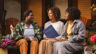 women talking on a porch