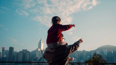  Father carrying his daughter and thinking about her future.