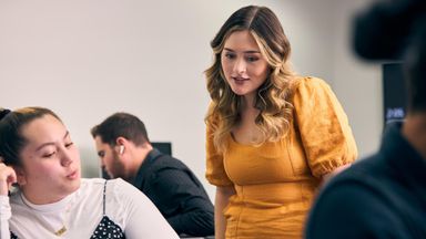 Female interns reading laptop and smiling