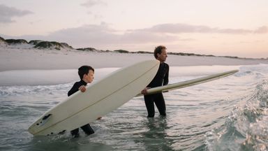 Father and son enjoy surfing trip while celebrating financial freedom and a solid plan with Northwestern Mutual