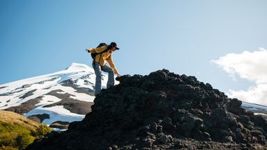 Hiker summits mountain range  