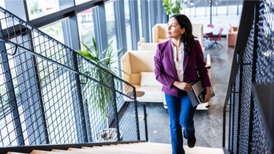 Woman thinking about what she read in Northwestern Mutual’s Quarterly Market Commentary.