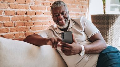 Portrait of man using smartphone at home