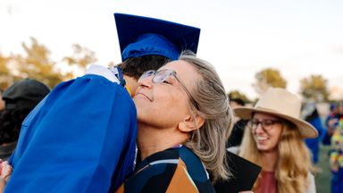 Grandmother hugs graduate 