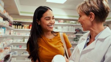 Pharmacist assisting client with making an HSA-eligible purchase.