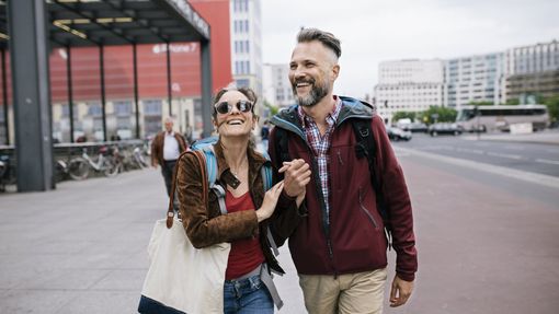 Couple walking along a street discussing holistic wealth management