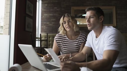 A young couple reviews their finances together