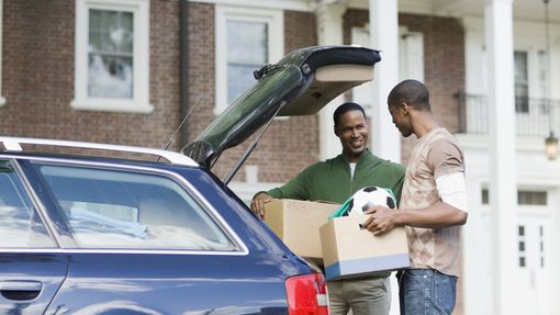 Father helping his son move out of college.