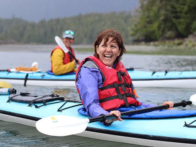 couple kayaking while on mid-cruise adventure