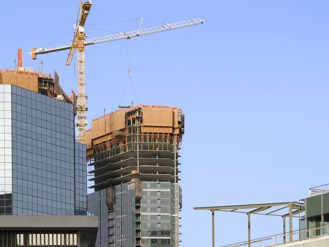 Crane rises above a skyscraper in construction 