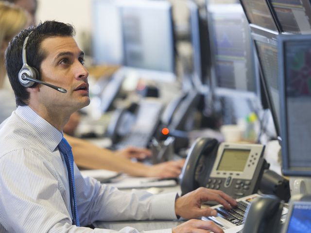 a man working at a trading desk at a financial firm